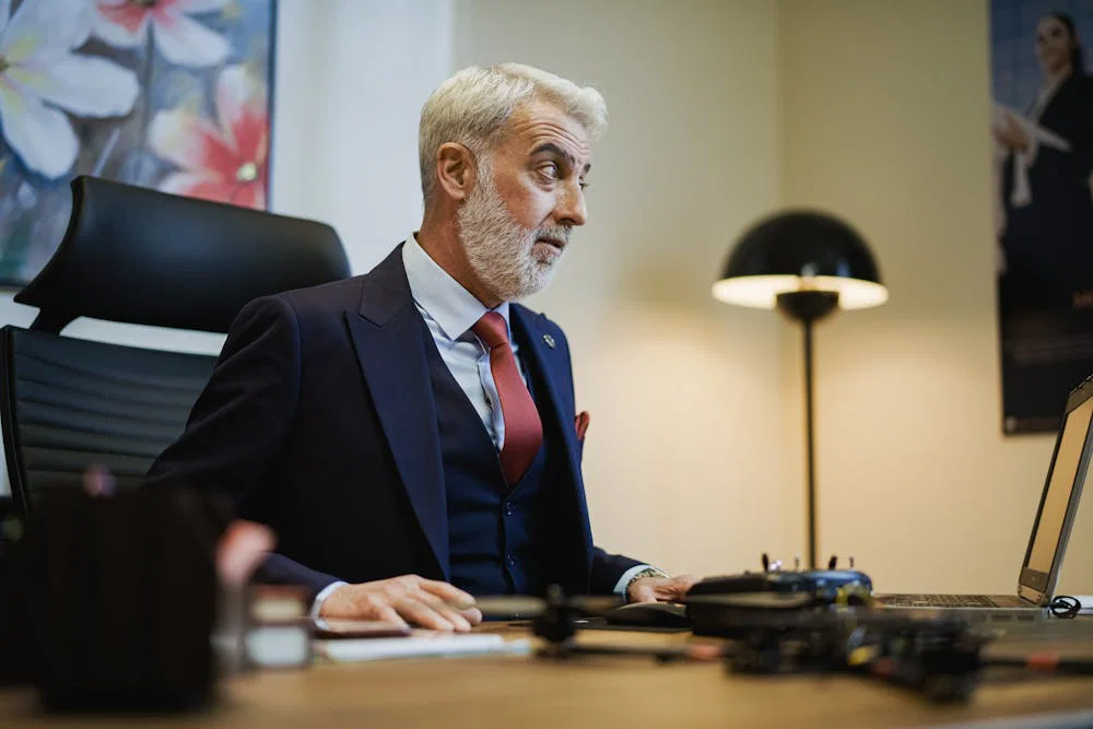 A male corporate executive at his desk in an office